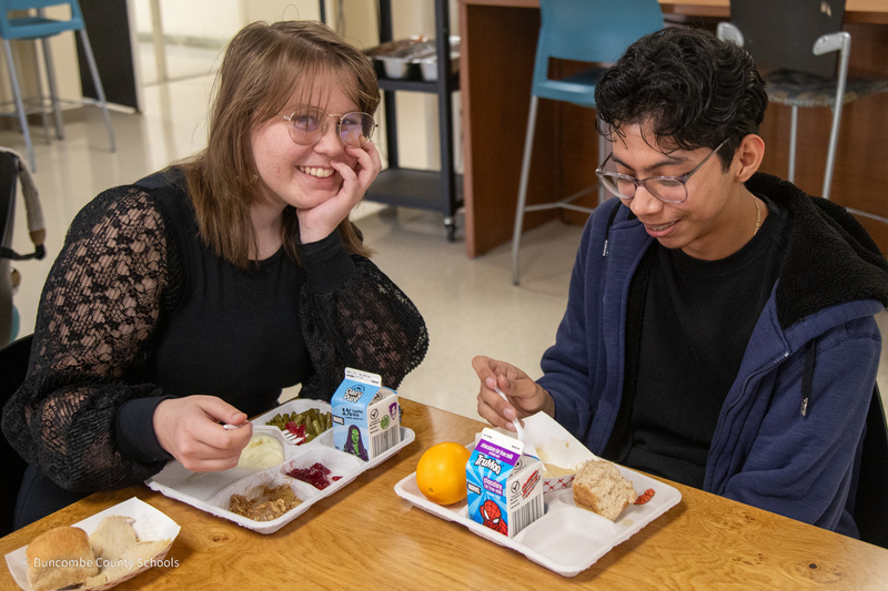 Two Early College students sitting at a table eating lunch