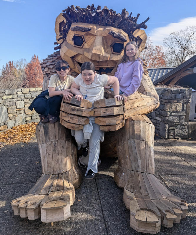 Students on Troll Sculpture at the NC Arboretum