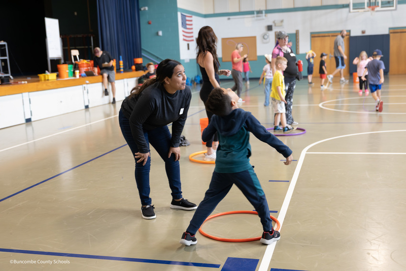 student playing with his mom
