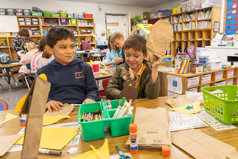 Two students work on a puppet project