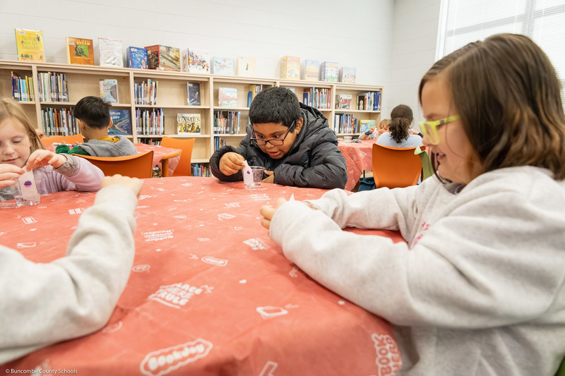 A student reacts with wonder at a color changing experiment.