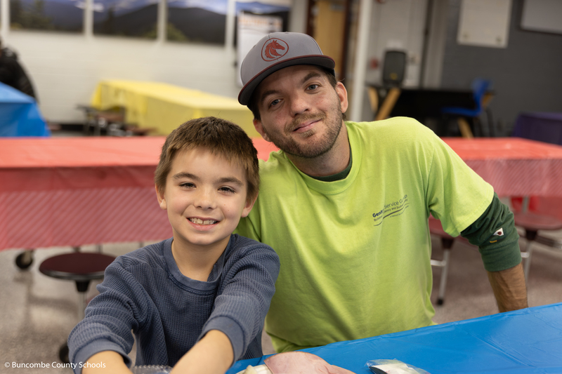Father and son sitting at a table enjoying a delicious meal together. 