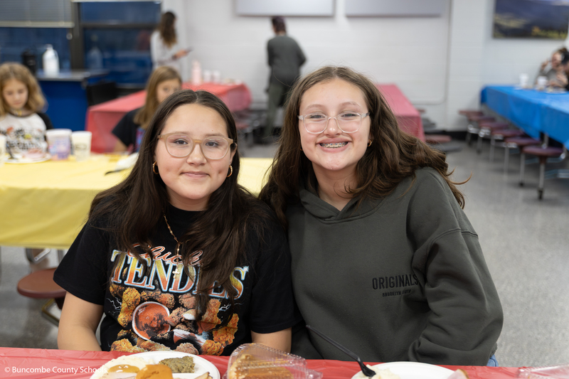 Two sisters enjoying a meal together. 