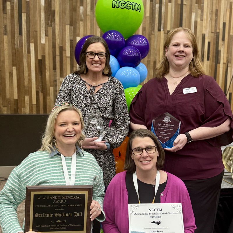 Ms. Hill and Ms. Stowe stand in front of Ms. Macarelli and Ms. McPherson. All are holding their awards.