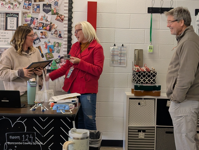 Melanie from Mix 96.5 presents Ms. Choi with a plaque