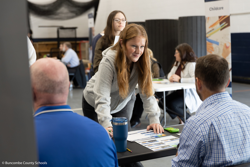 Student listening to what a banking official has to say.