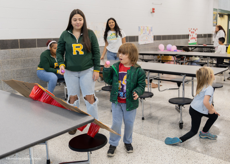 student playing the ball toss game