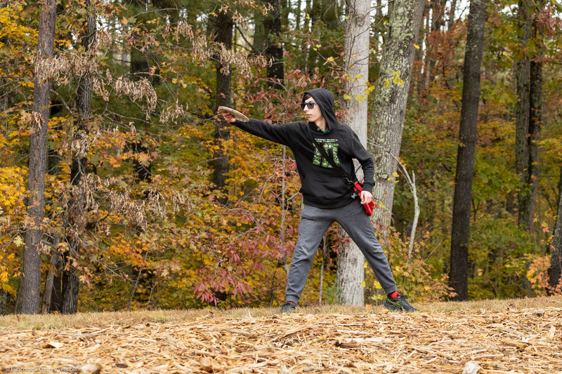 A student releases a disc off the tee.