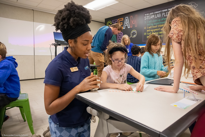 Students work on a scrolling art project.