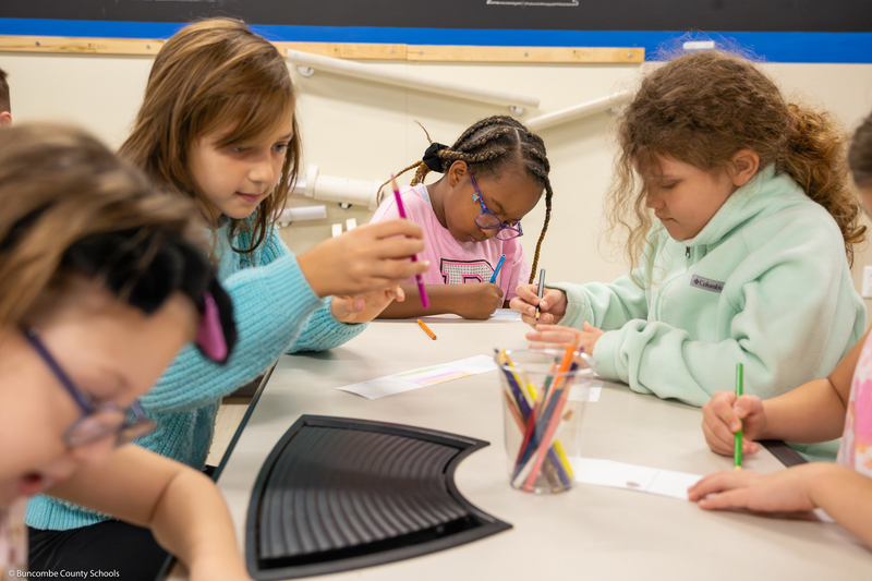 Students work on a scrolling art project.