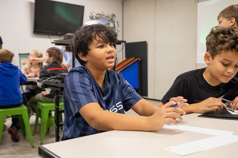 Students work on a scrolling art project.