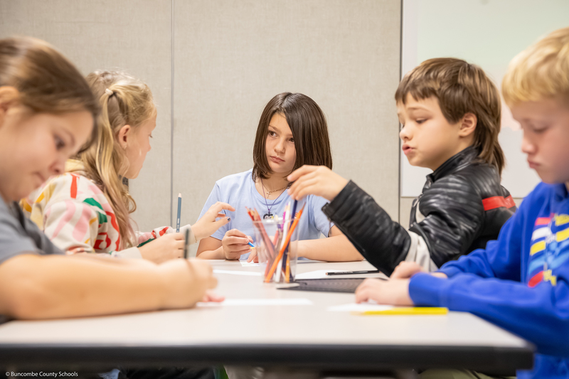 Students work on a scrolling art project.