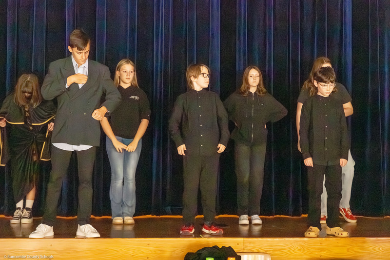 A group of students performs a skit during the dress rehearsal.