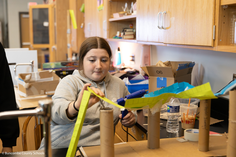 Female student constructing elements of the groups rollercoaster. 