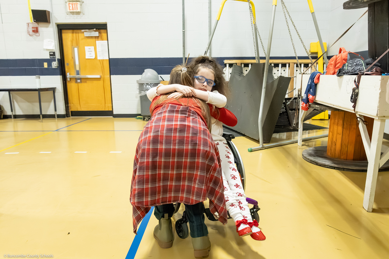 A student hugs a teacher.