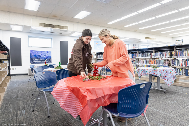 Enka High SGA members decorate a table.