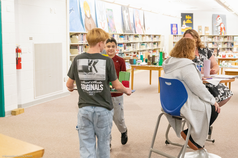 Students carry their Future City diorama on their way to give a presentation.