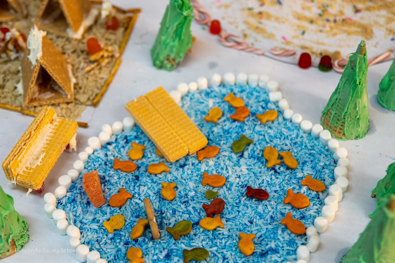 A lake made of blue candies and Pepperidge Farm Goldfish. Wafer crackers are being used for a dock on the lake.