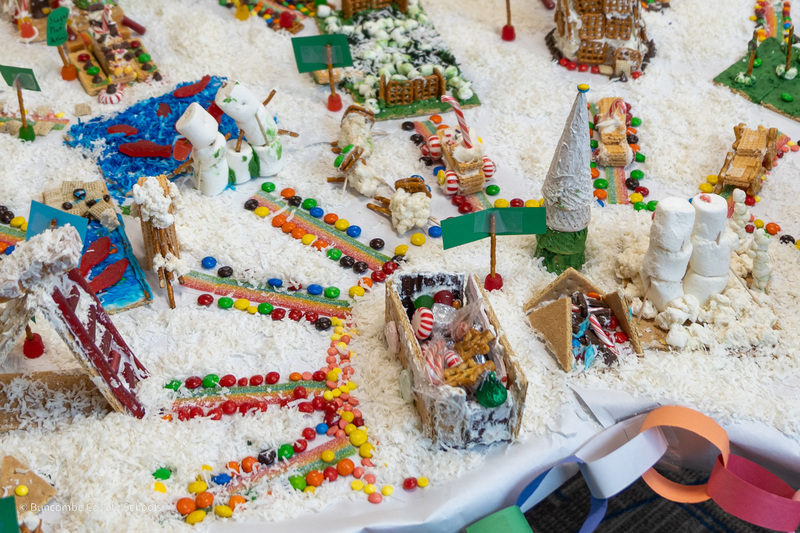 Overhead shot of gingerbread house creations on a table.