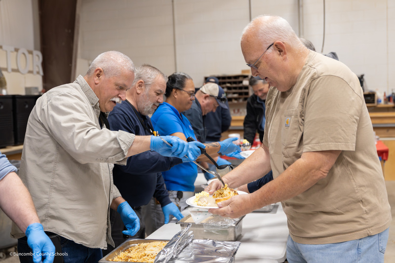 Man getting eggs at breakfast buffet