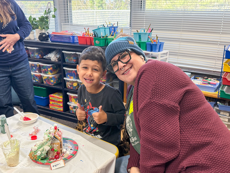 student decorates house with parent