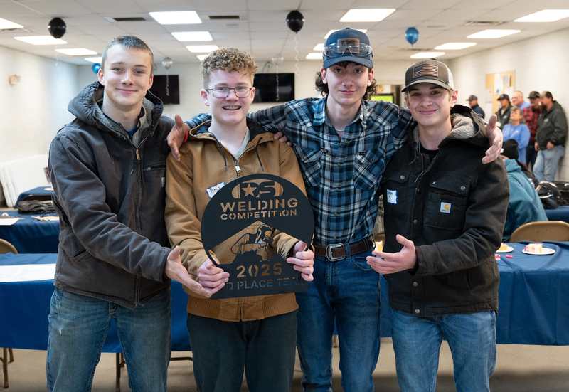 Members of the 2nd place overall winners from A.C. Reynolds High pose with their trophy