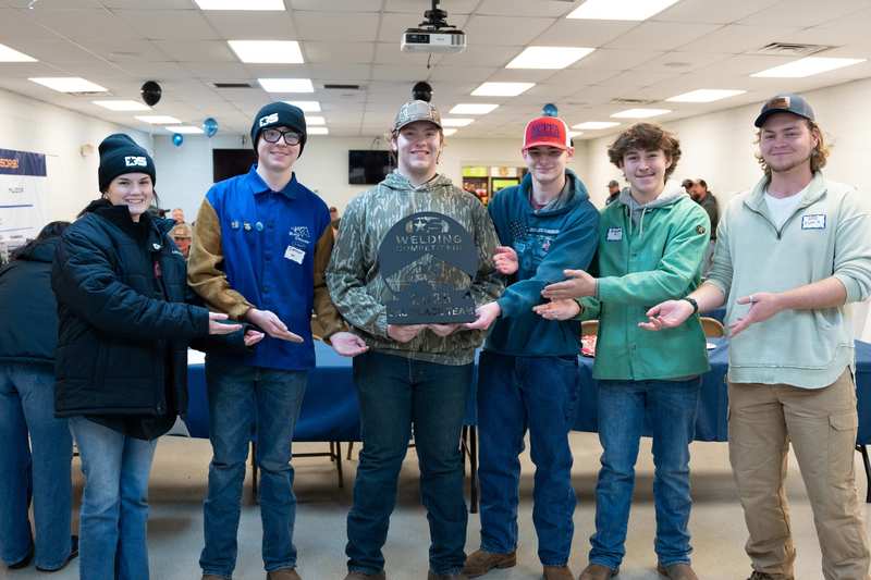 Members of the overall 3rd place winning team from Enka High pose with their trophy