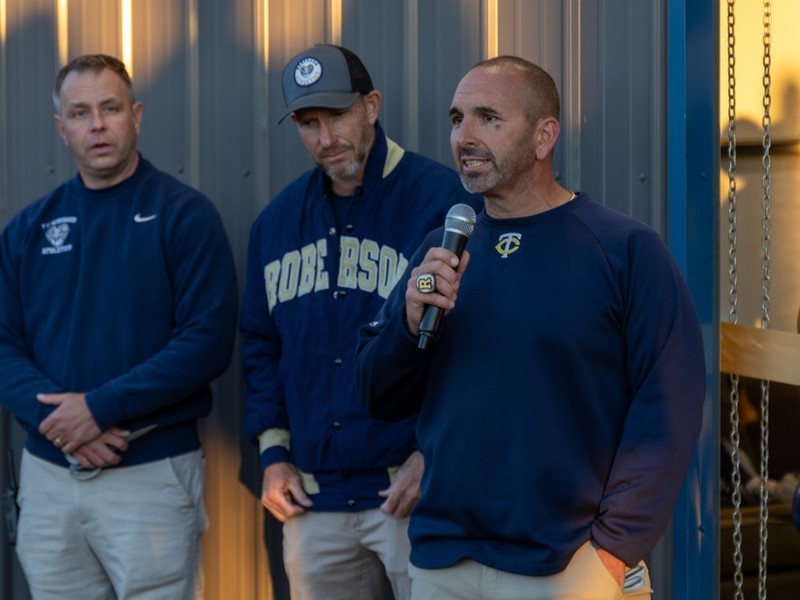 Coach Filipek speaks into a microphone