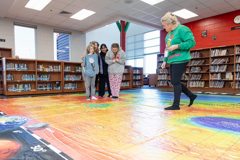 Haley Stamey and students explore the Giant Mars Map.