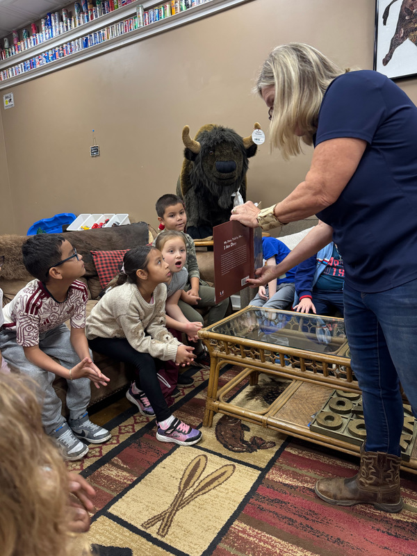 Student in awe of a story being read to them by the owner of Buffalo Creek Vacations.