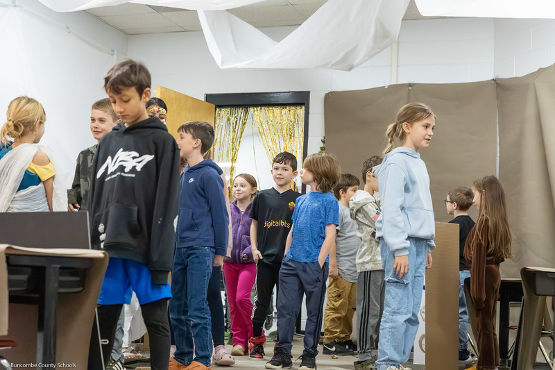 Visiting students enter the classroom.