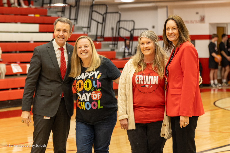 The Woodfin Elementary teacher of the Year and Woodfin Elementary Principal pose for a phot on the court standing between BCS Superintendent Dr. Rob Jackson and Assistant Superintendent Dr. Jamie Johnson