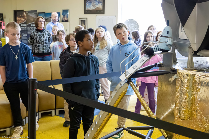 A student looks at a replica lunar module.