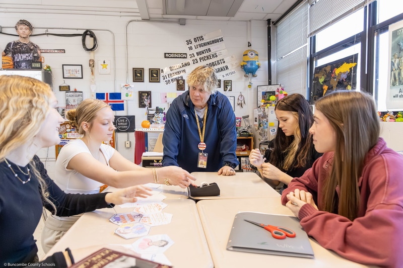 Students work on part of the quilt inside the classroom while Chris Brown instructs them.