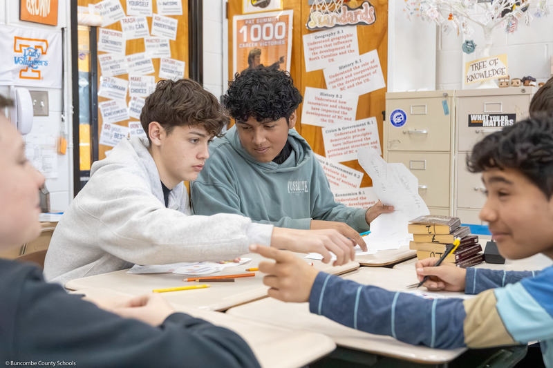 Students work on part of the quilt inside the classroom.