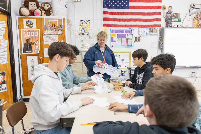 Students work on part of the quilt inside the classroom while Chris Brown instructs them.