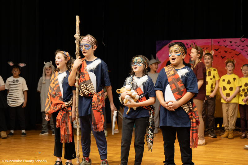 Students on stage performing the Lion King Jr. 