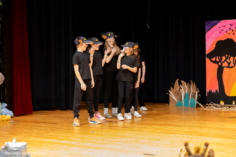 Students on stage performing the Lion King Jr.
