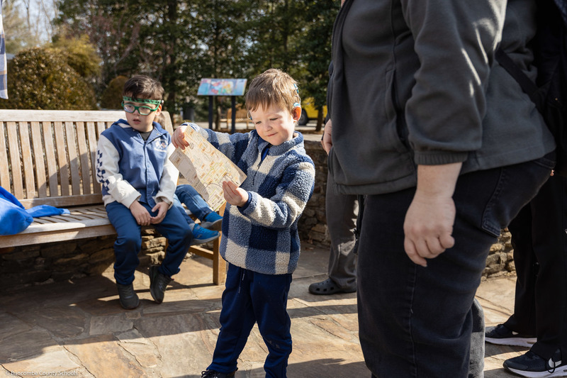 A student reads a map at the Arboretum.