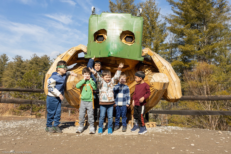 Students pose in front of one of the trolls.