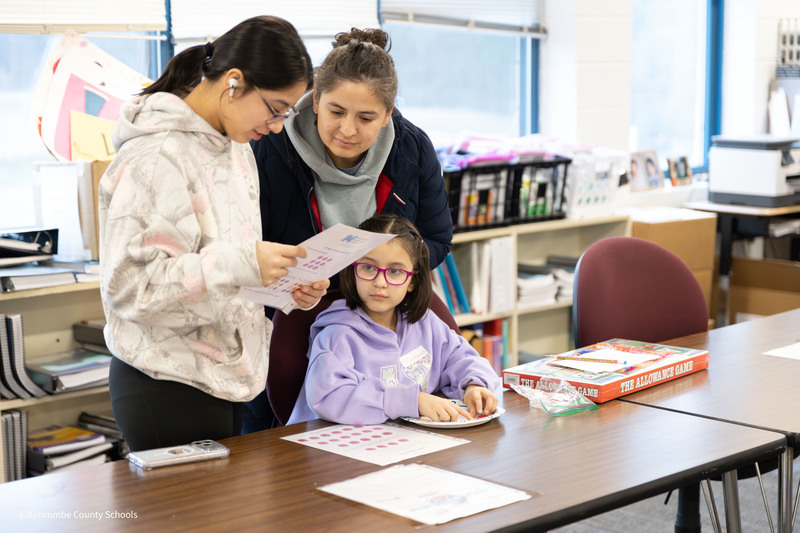 Student with family playing the apple game