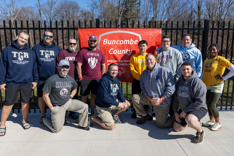 School Resource Officers pose in front of the Special Olympics banner before the Polar Plunge.