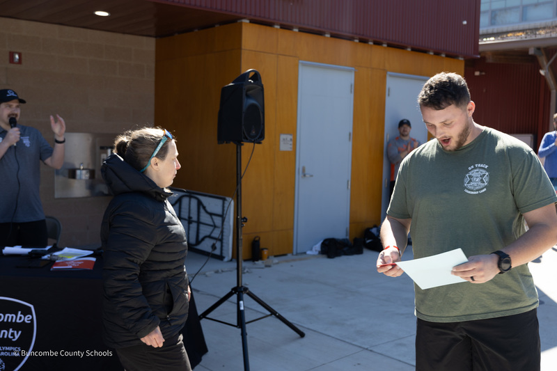 Dep. Morgan gets is handed a certificate by a Polar Plunge organizer.