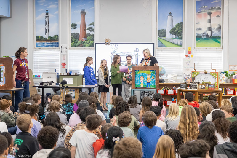 Four students demonstrate Oakley's crankie box.