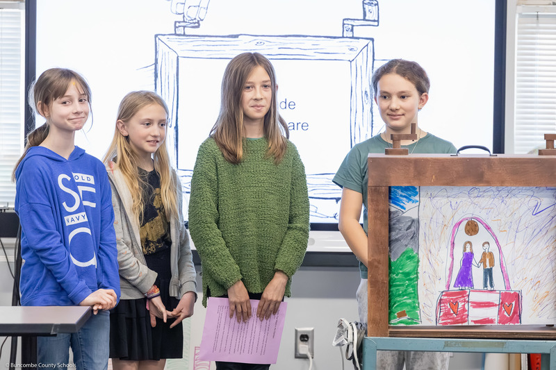 Four students demonstrate Oakley's crankie box.