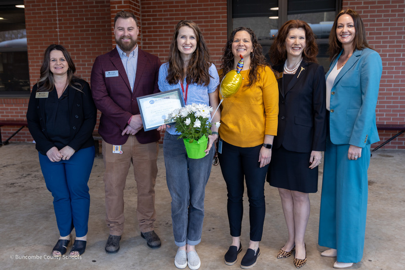 Ms. Houchard, Principal Bradley McMahan, Ms. Sanders, Assistant Principal Megan Davis, Ms. Martin, and Dr. Johnson pose for a photo outside of Owen Middle School.