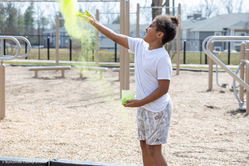 Student throwing powder up in the air. 