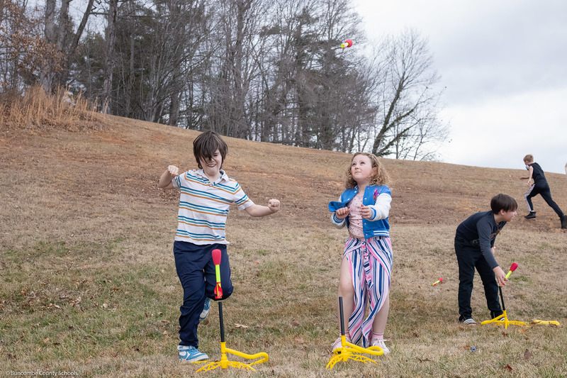 Two students stomp on rocket launchers.