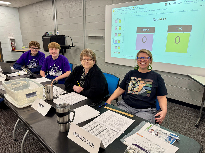 Adult and student volunteers pose for a picture.