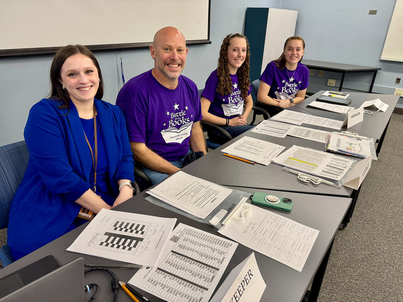 Adult and student volunteers pose for a picture.